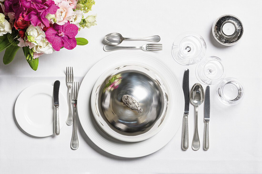 A place setting with a cloche