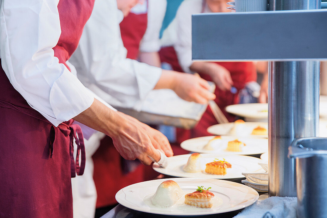 Professional chefs plating food