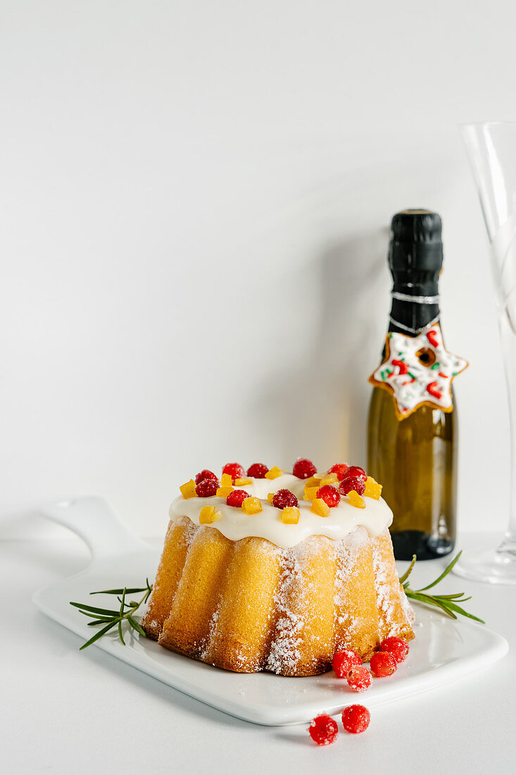 Orange bundt cake glazed and decorated with cranberries for Christmas