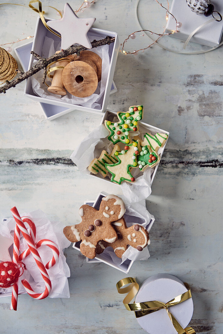 Gingerbread people and butter biscuits in gift boxes