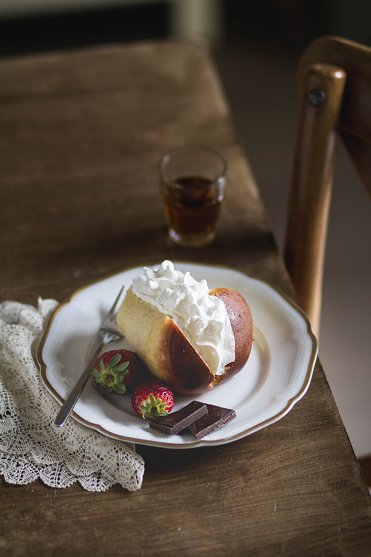 Traditional Neapolitan rum baba with whipped cream