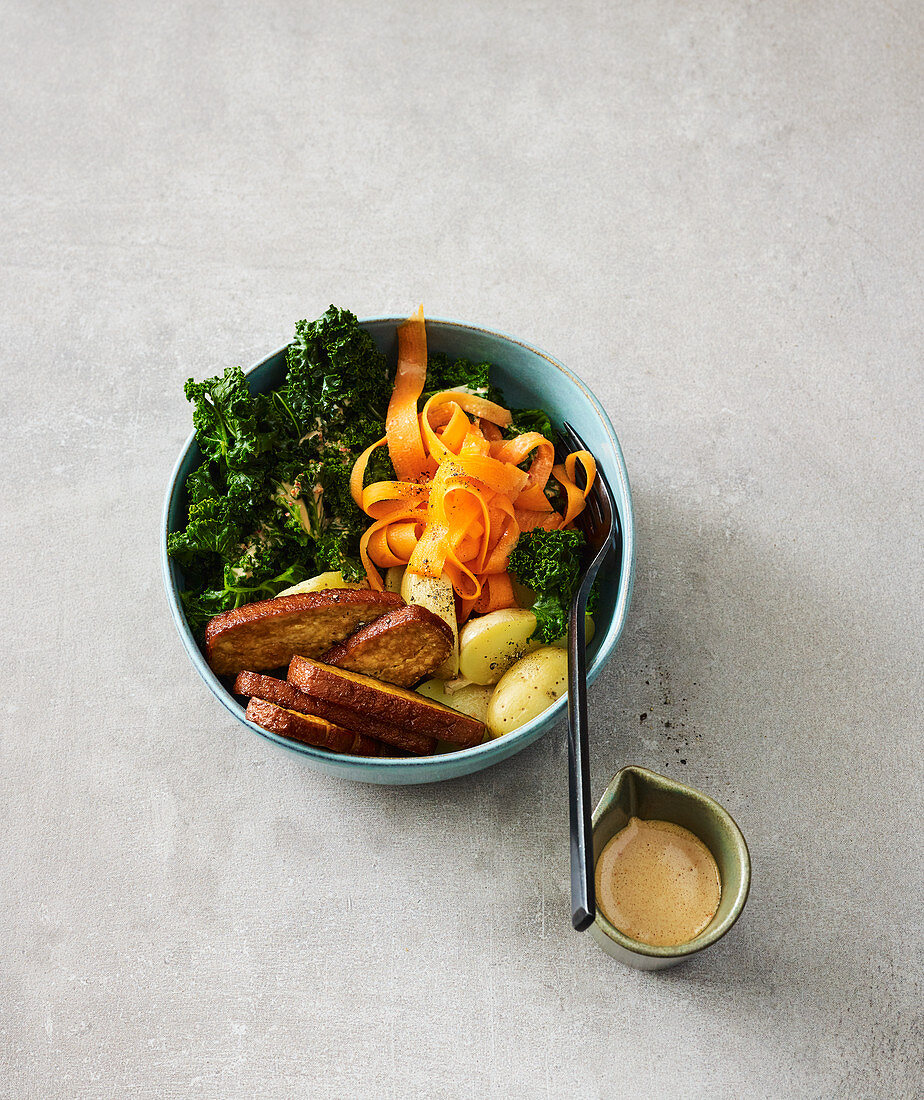 Kale and carrot bowl with a walnut sauce