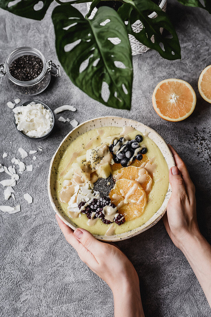 Bowl with pineapple orange chia blackberries blueberries and coconut flakes