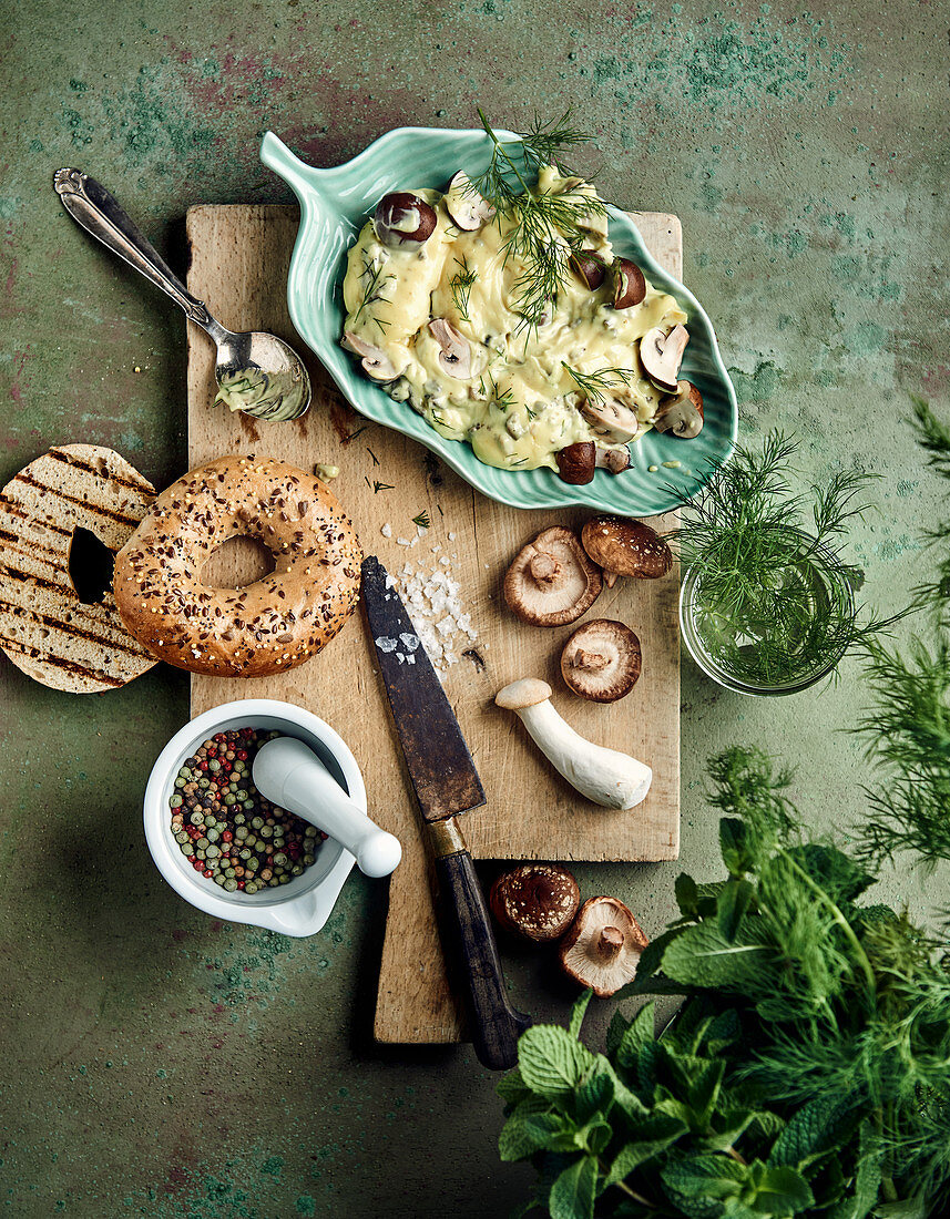 Mushrooms and turmeric mayonnaise with fresh herbs, mushrooms and bagels