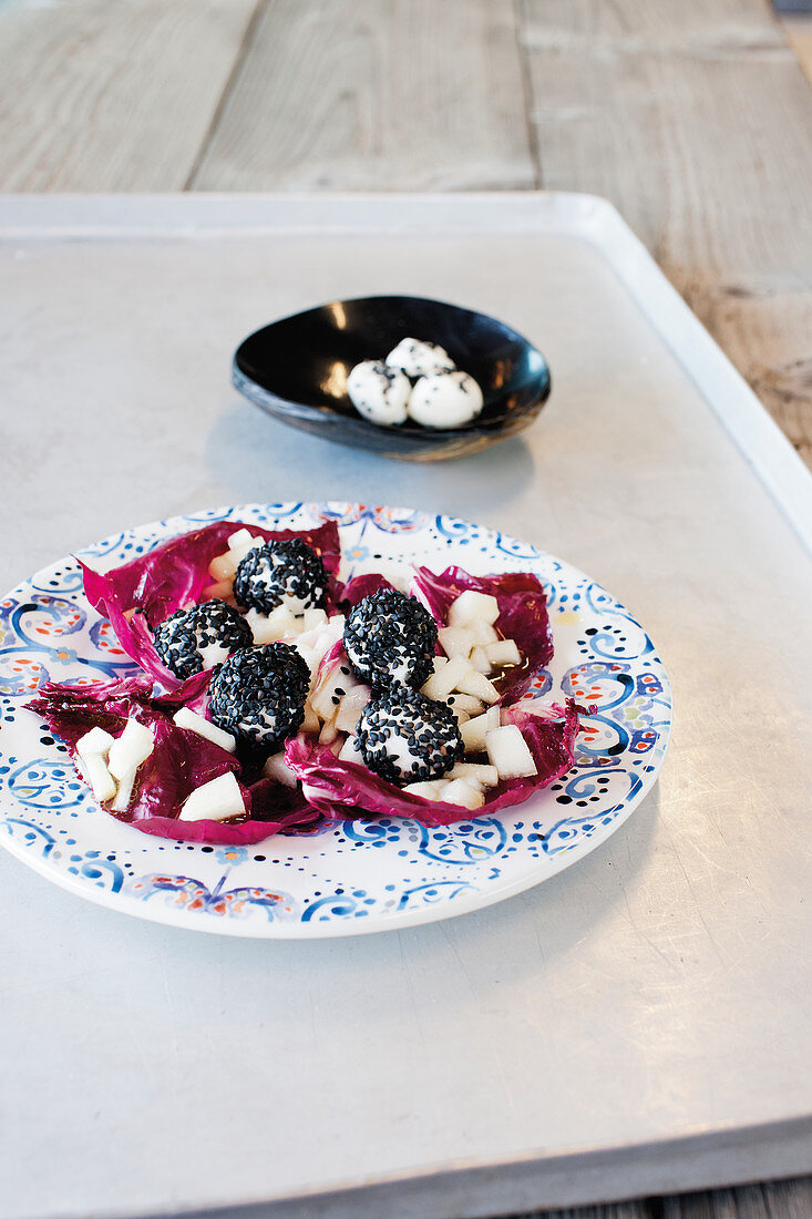 Radicchio and pear salad with black mozzarella balls