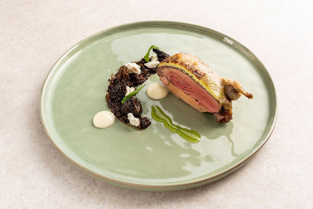 Pigeon-stuffed quail with morel mushroom rilette and Bibbeleskäse (white cheese made from quark with herbs)
