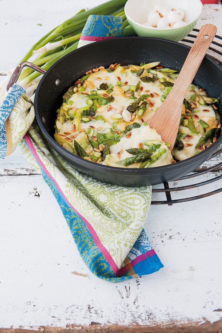 Omelet with mozzarella, green asparagus, and pine nuts