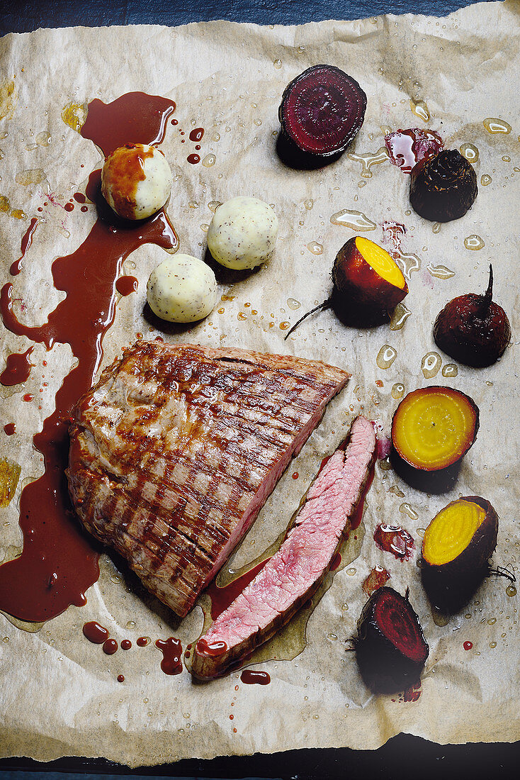 Flank steak with red and yellow beetroot with potato and poppy seed balls