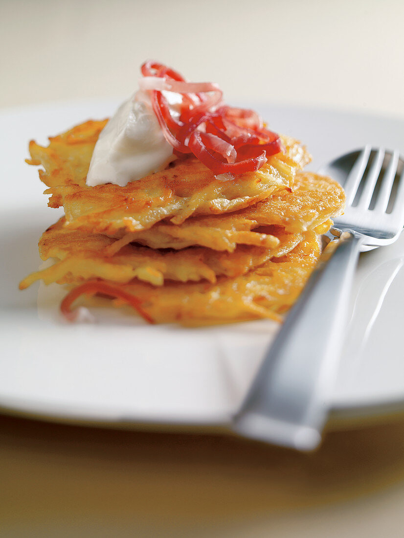 Potato fritters with chopped ham and sour cream