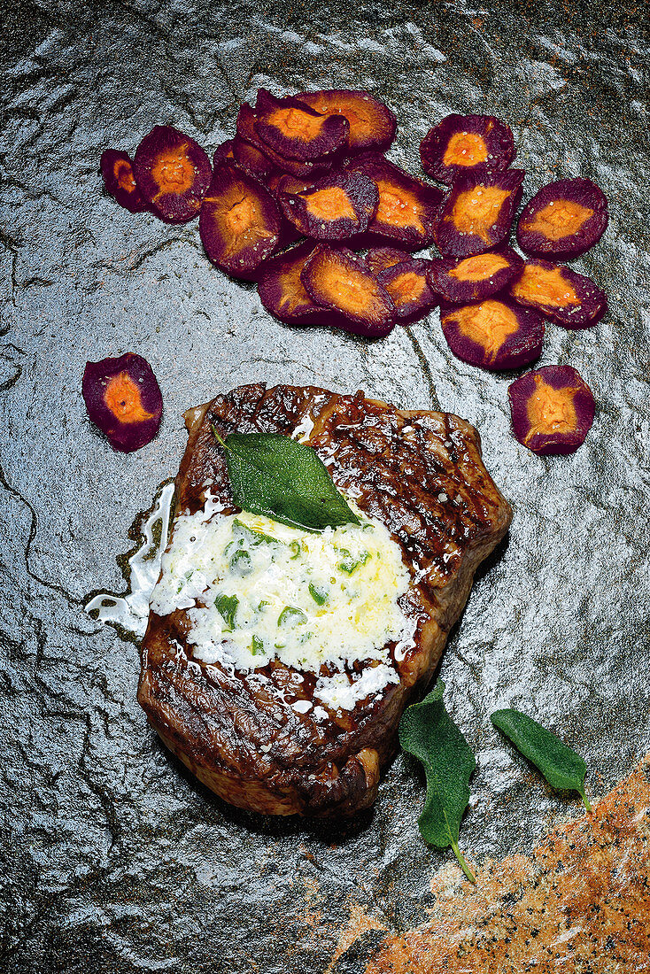Grilled rib-eye steak with vintage carrots, sage and lemon butter