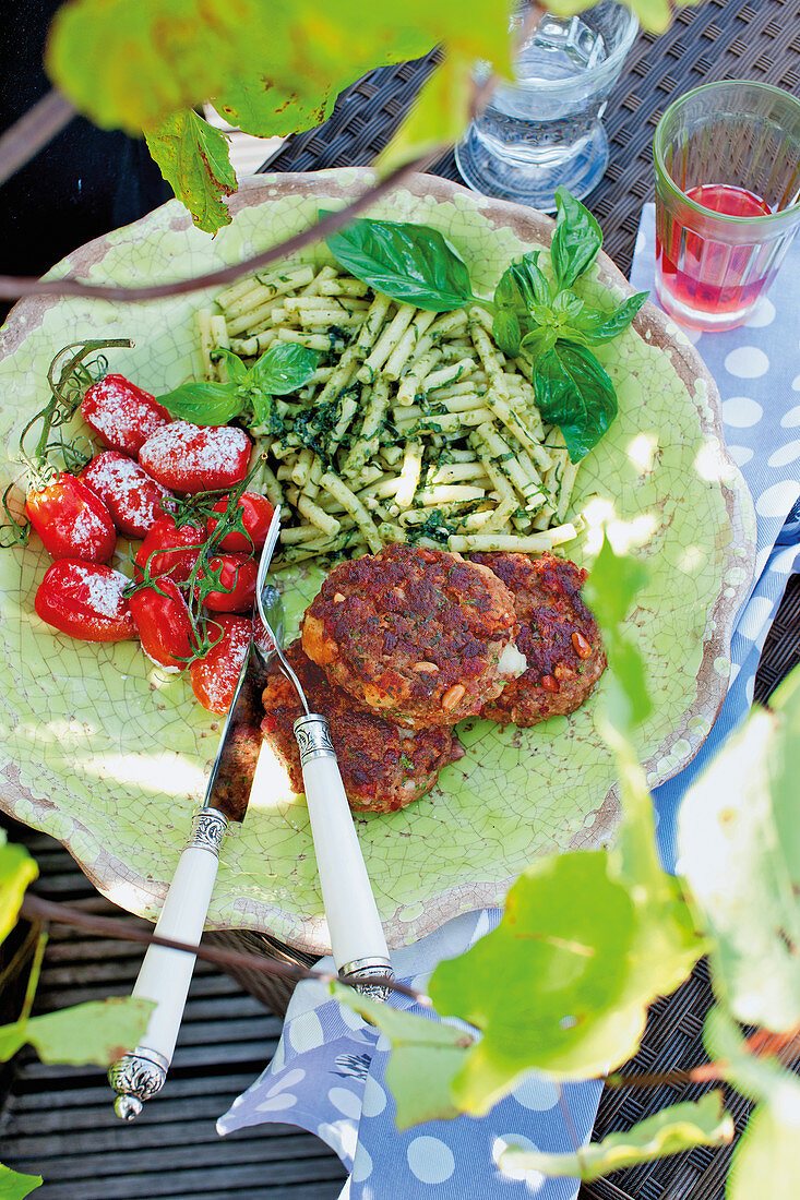 Stuffed mozzarella veal burgers with herb pasta and tomatoes