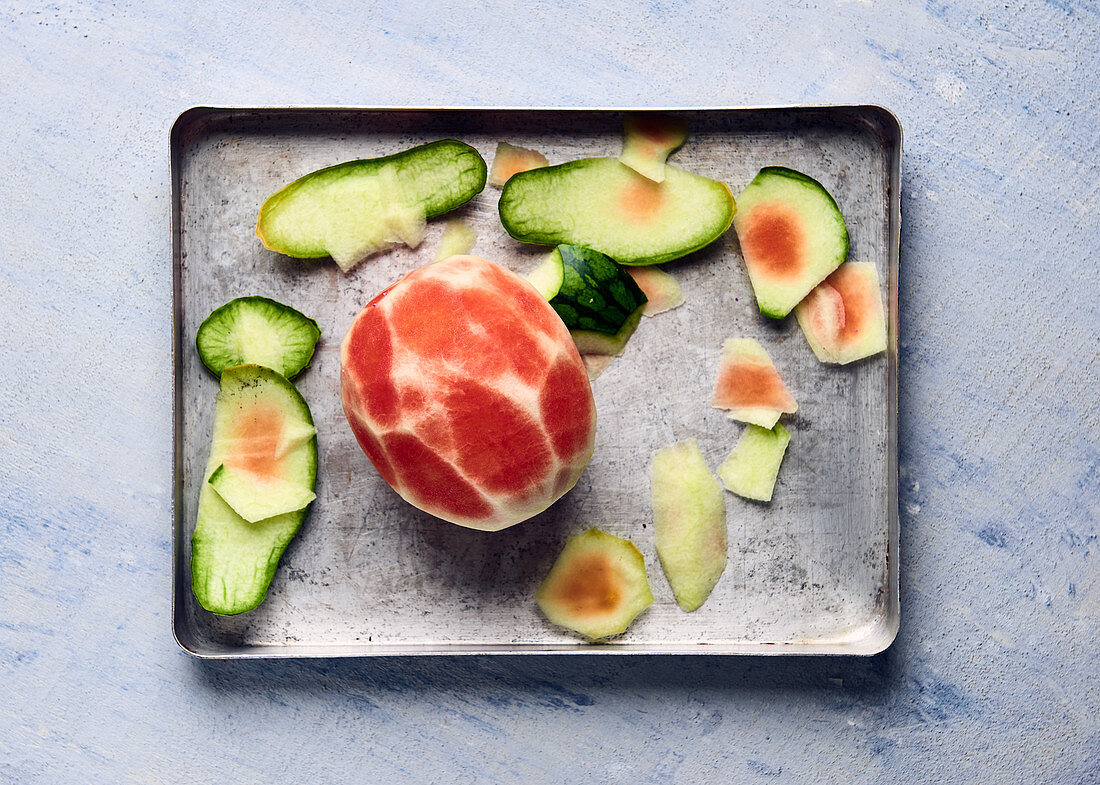 Peeled watermelon on baking sheet