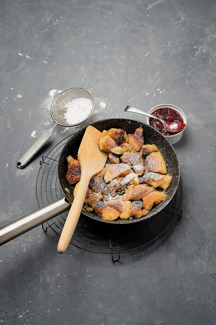 Shredded pancake in a pan with lingonberry jam