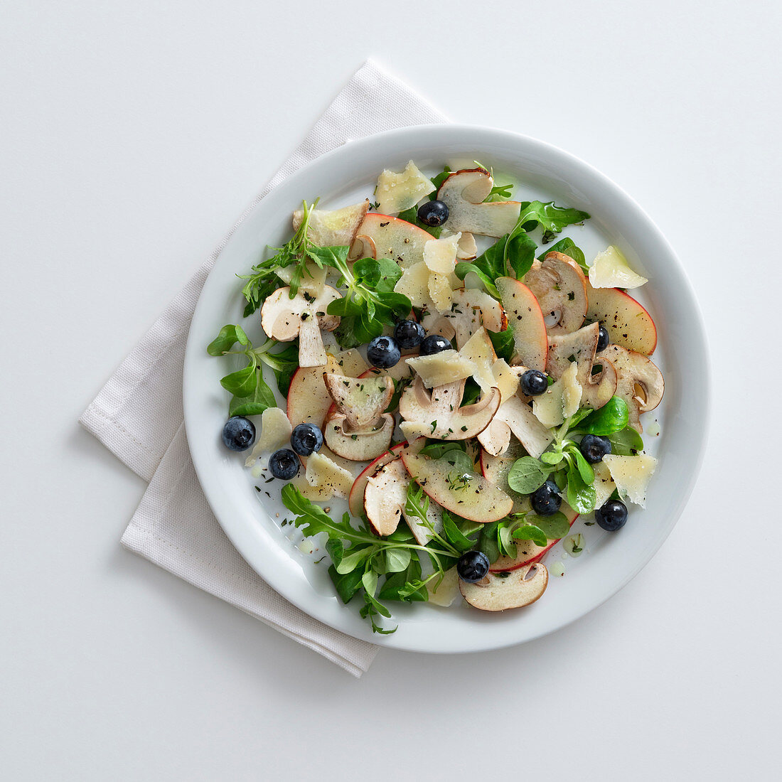 Apple and porcini mushroom salad with blueberries