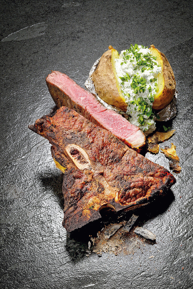 A 'caveman-style' T-bone steak with a baked potato and herb quark