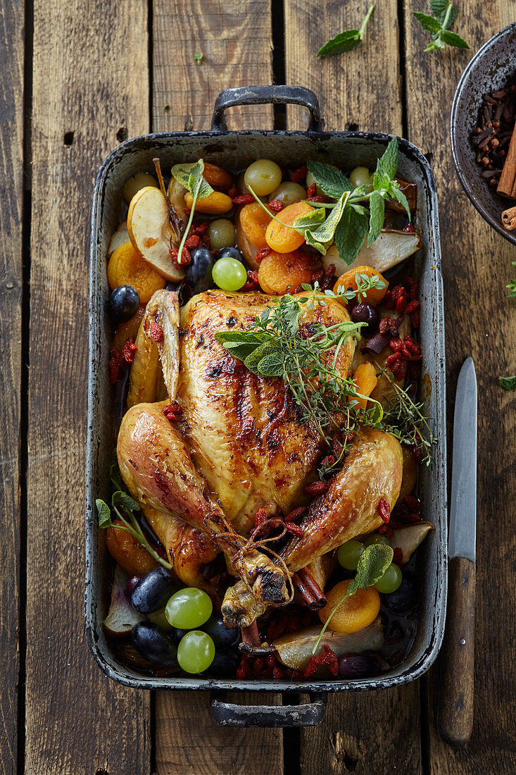 Autumn roasted chicken with grapes and apples