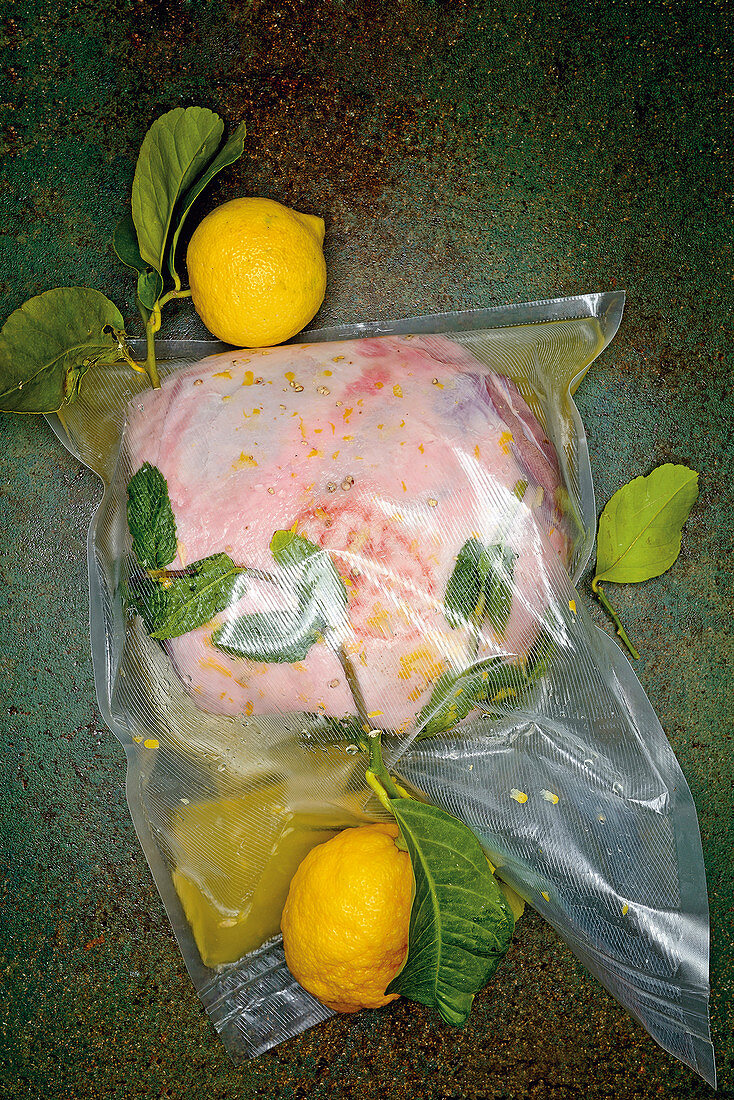 Leg of leg being marinated in Limoncello