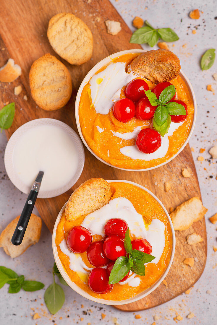 Pumpkin and carrot cream soup with roasted cherry tomatoes