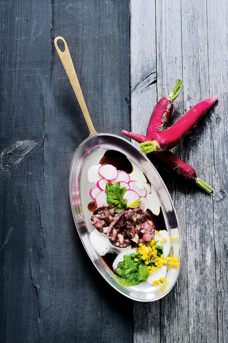 Fried black pudding on glazed radish with smoked potato sauce