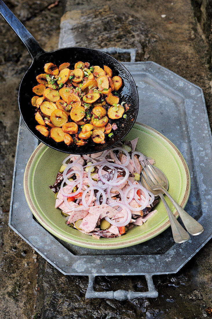 Classic cold meat salad with fried potatoes and bacon