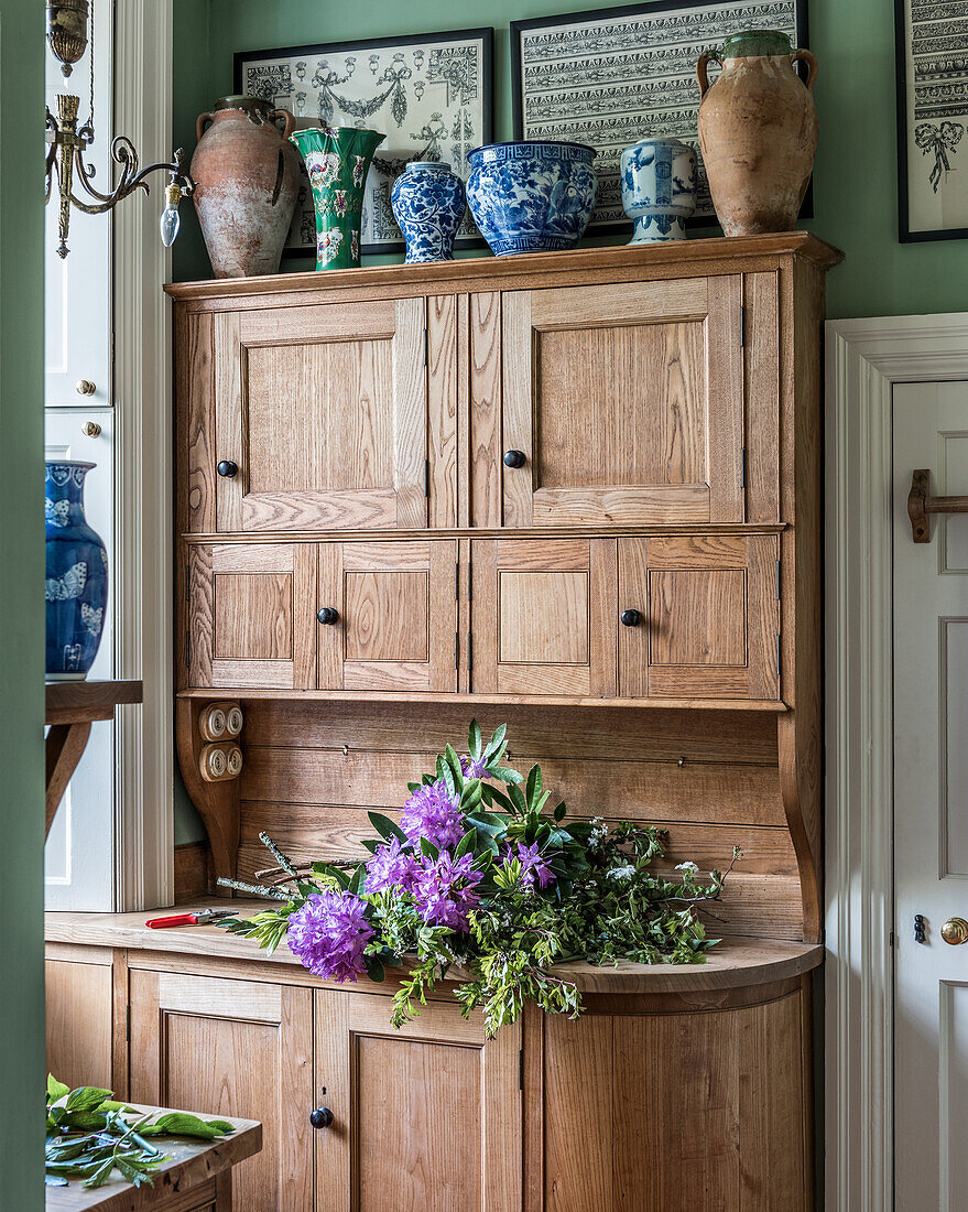 Bunch of rhododendrons on the natural wood kitchen buffet