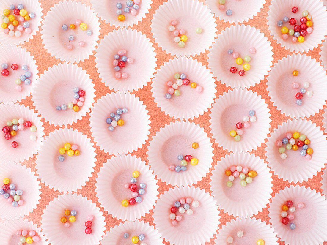 Colourful sugar pearls in paper cases for pralines
