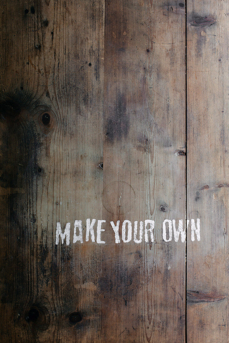 A wooden surface written with the words 'MAKE YOUR OWN'