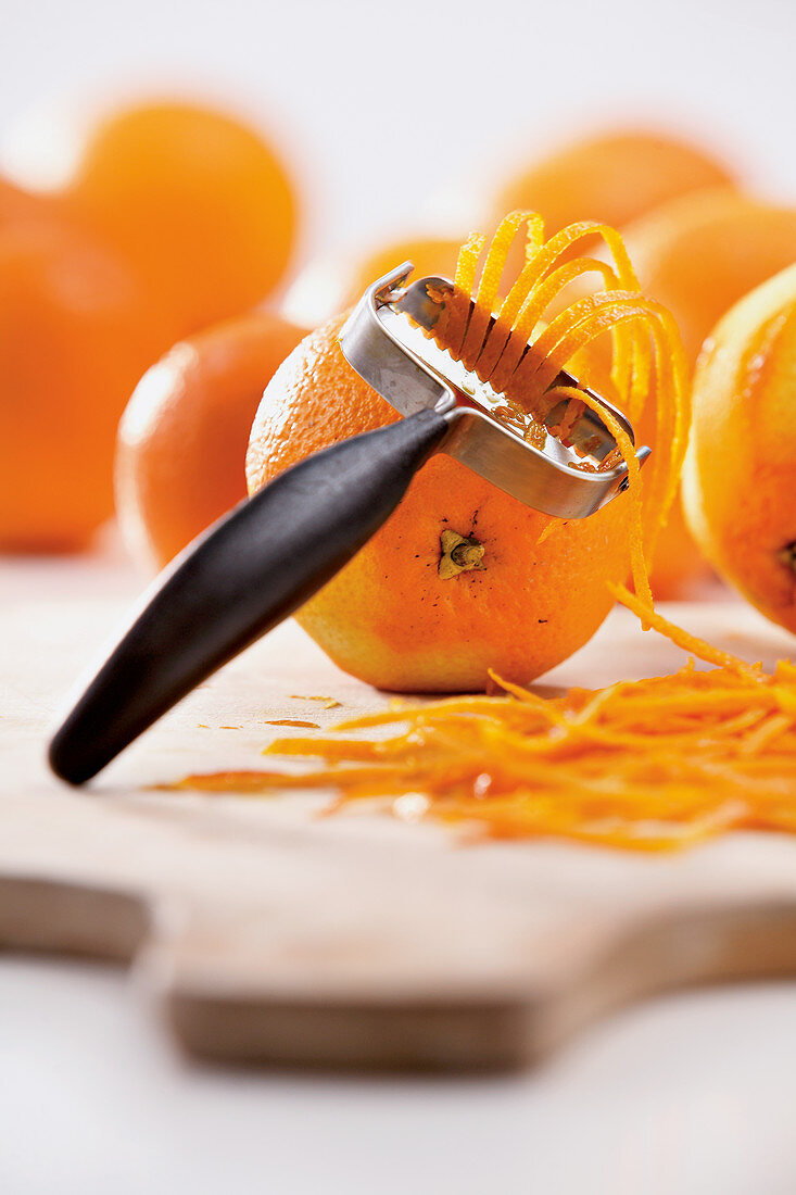 Peeling orange zest with a zester