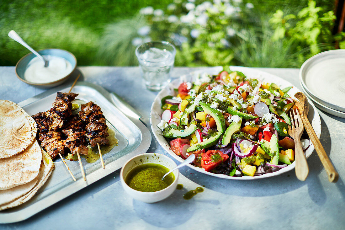 Kebabs with unleavened bread and vegetable salad with feta cheese