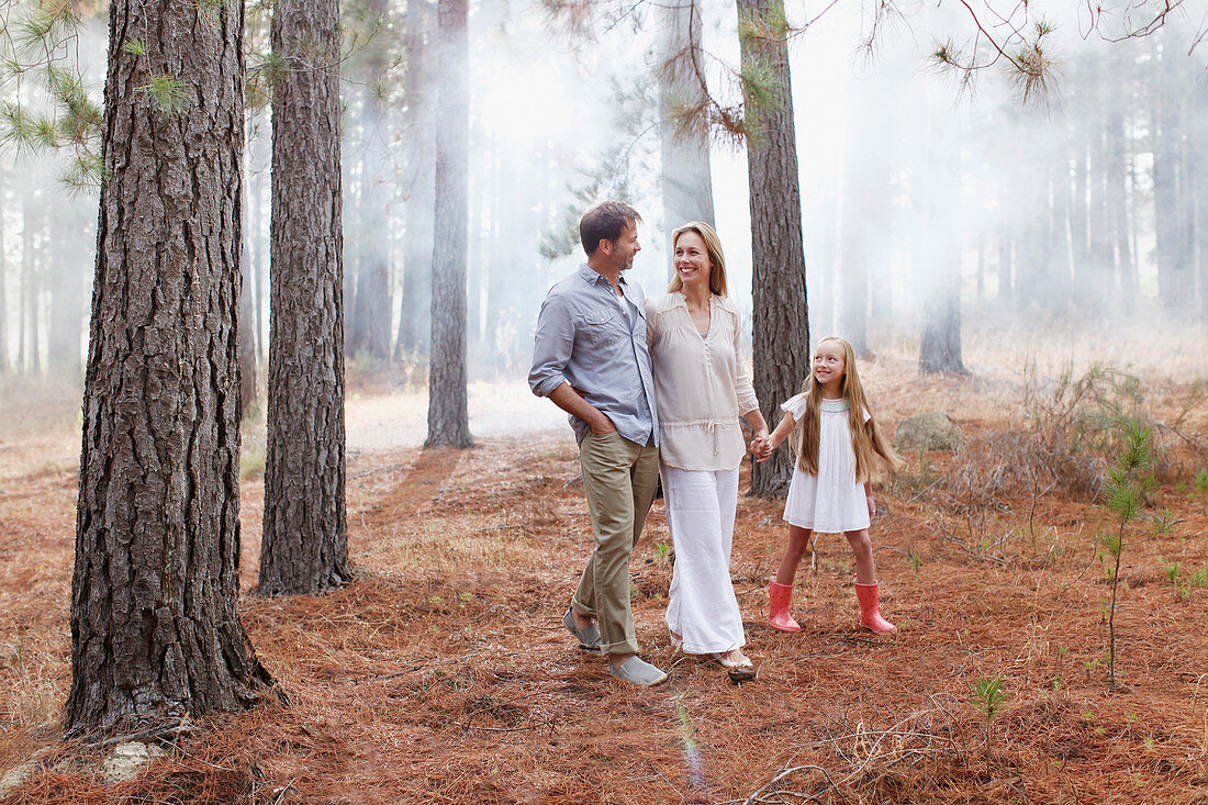 Happy family walking in woods