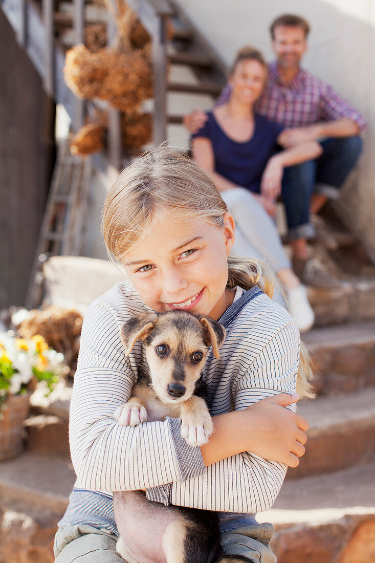 Portrait of smiling girl holding puppy