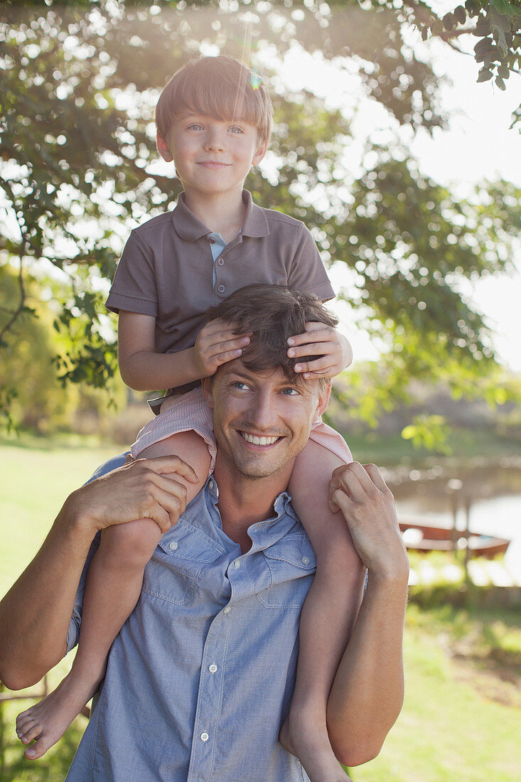 Father carrying smiling son