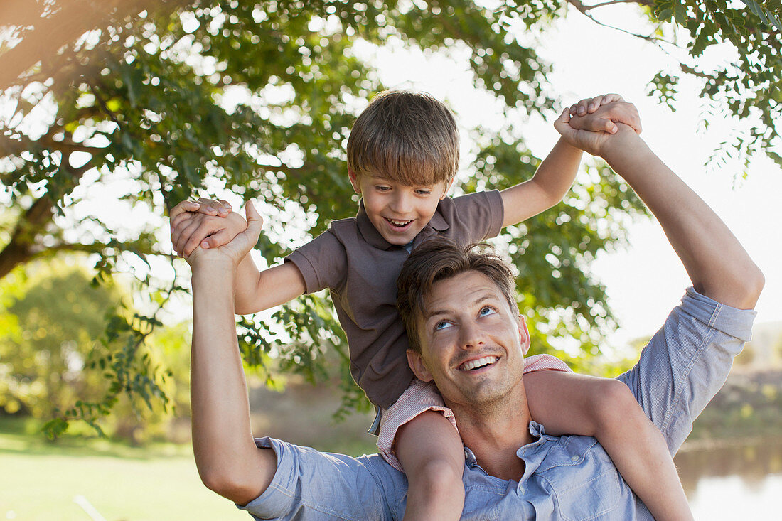 Smiling father carrying son