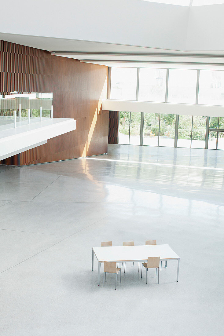 Table and chairs in empty office lobby