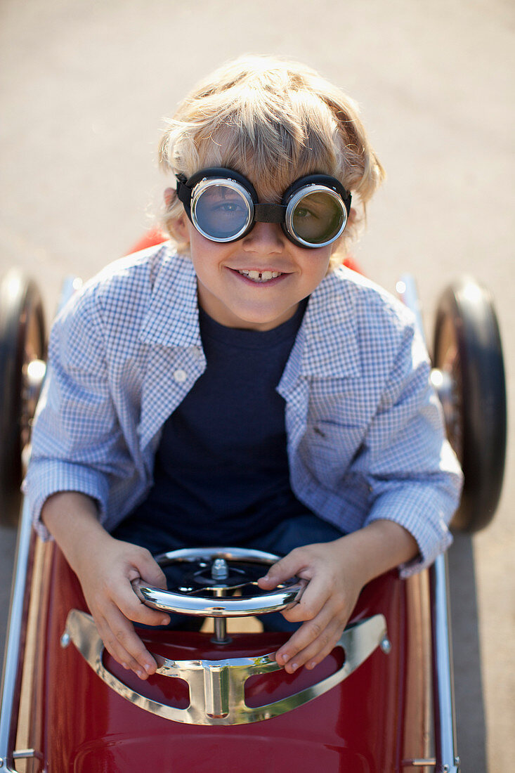 Boy wearing goggles in go cart