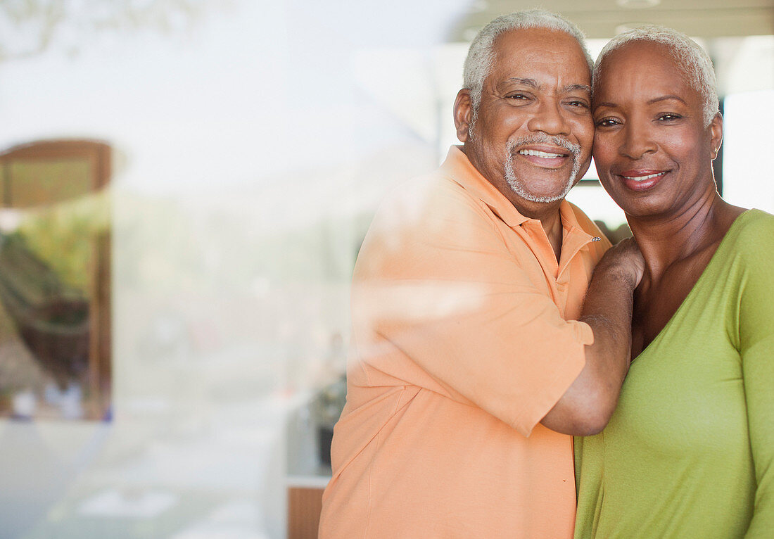 Older couple smiling by window