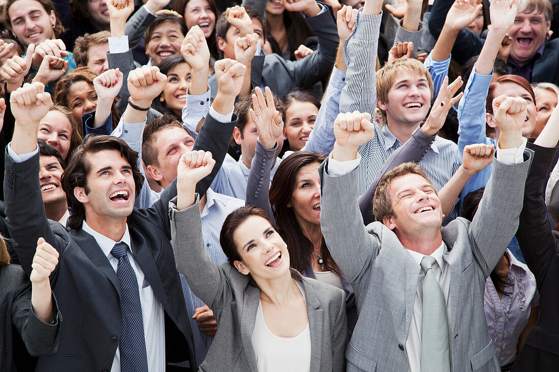 Smiling crowd of business people cheering