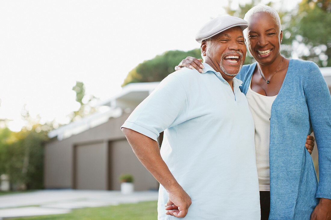 Older couple laughing together outdoors