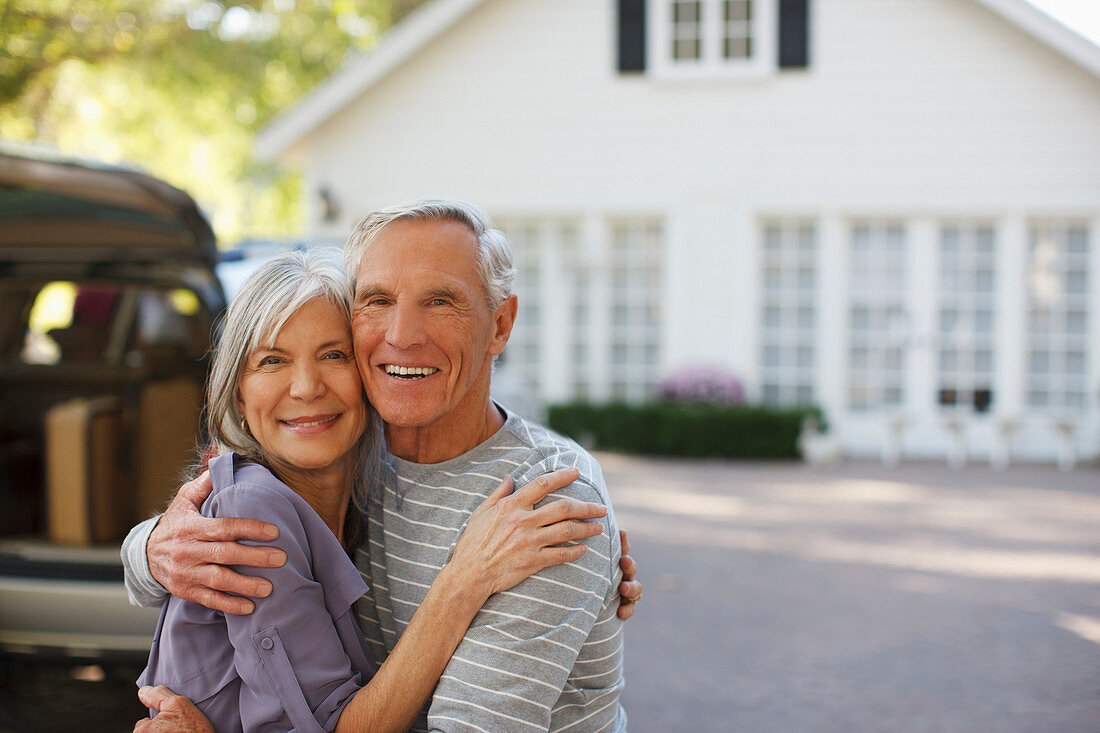 Smiling older couple hugging outdoors