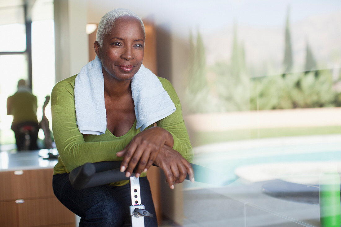 Older woman sitting on exercise bike
