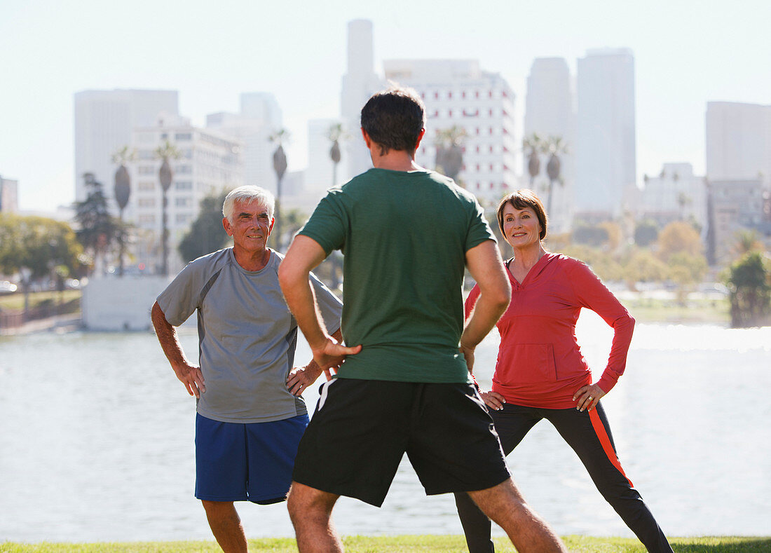 Older couple exercising with trainer