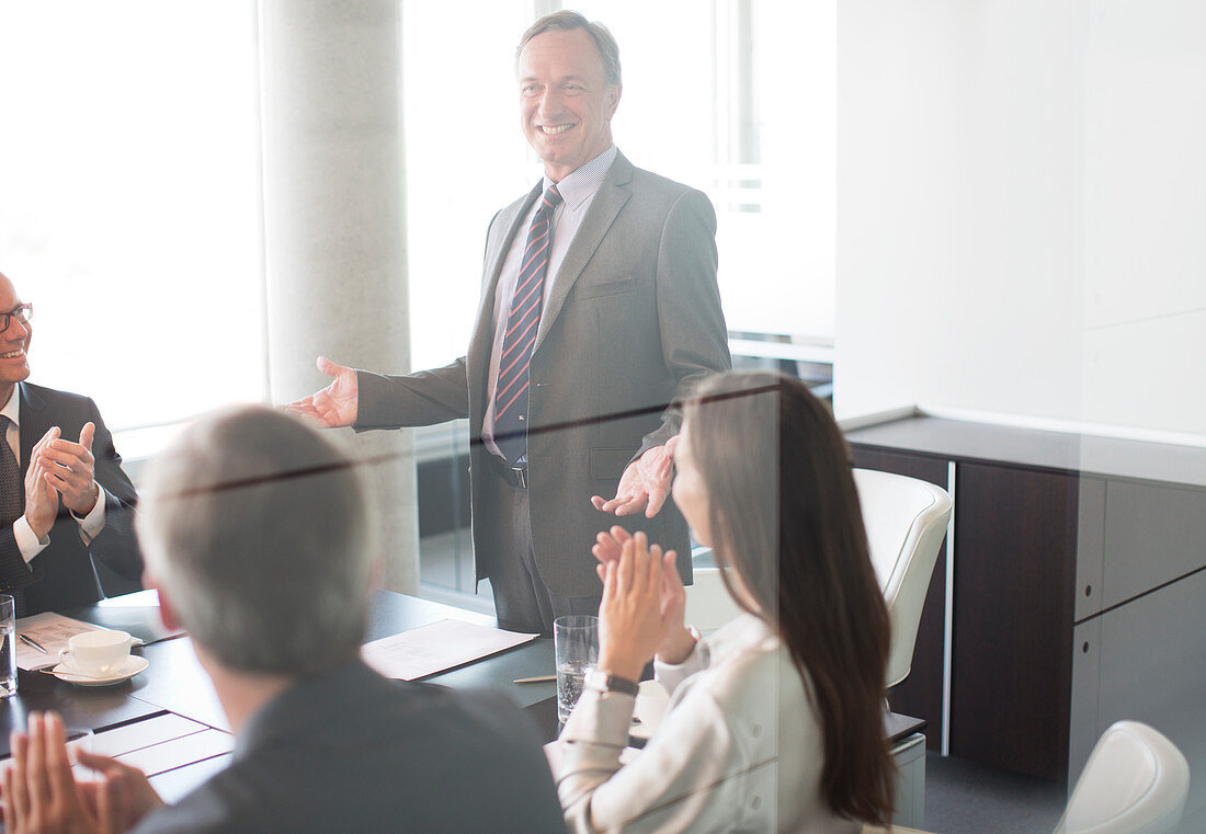 Business people applauding colleague