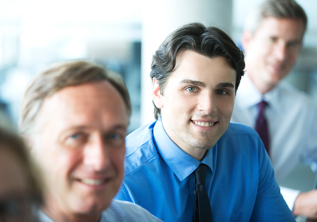 Businessmen smiling in meeting