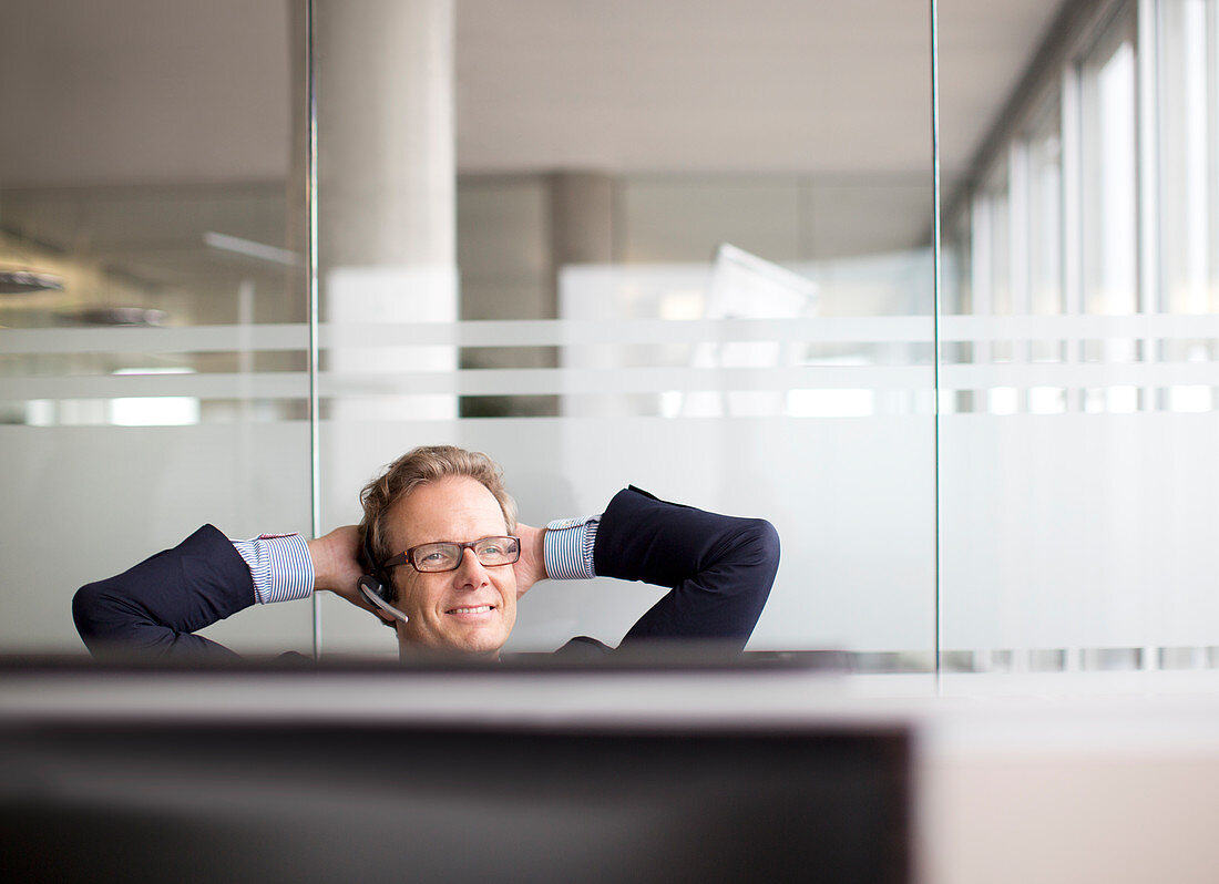 Businessman talking on headset in office