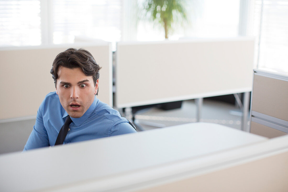 Surprised businessman working in office