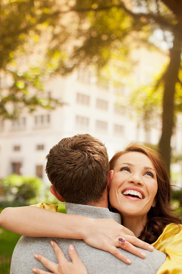 Couple hugging in urban park