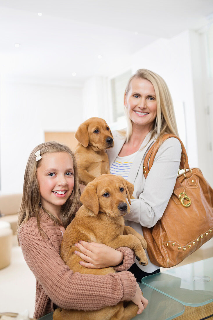 Mother and daughter holding dogs