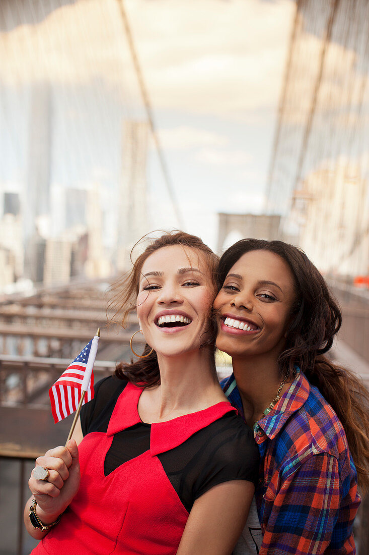 Smiling women waving American flag