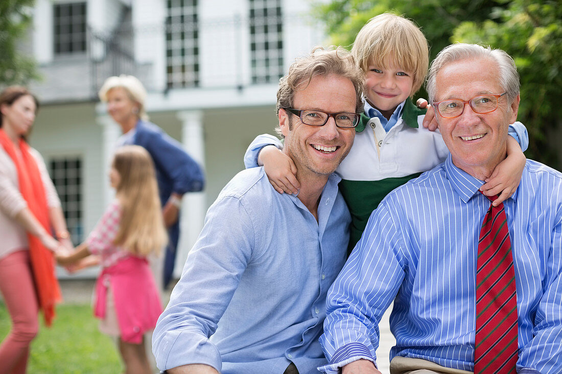 Three generations of men smiling together