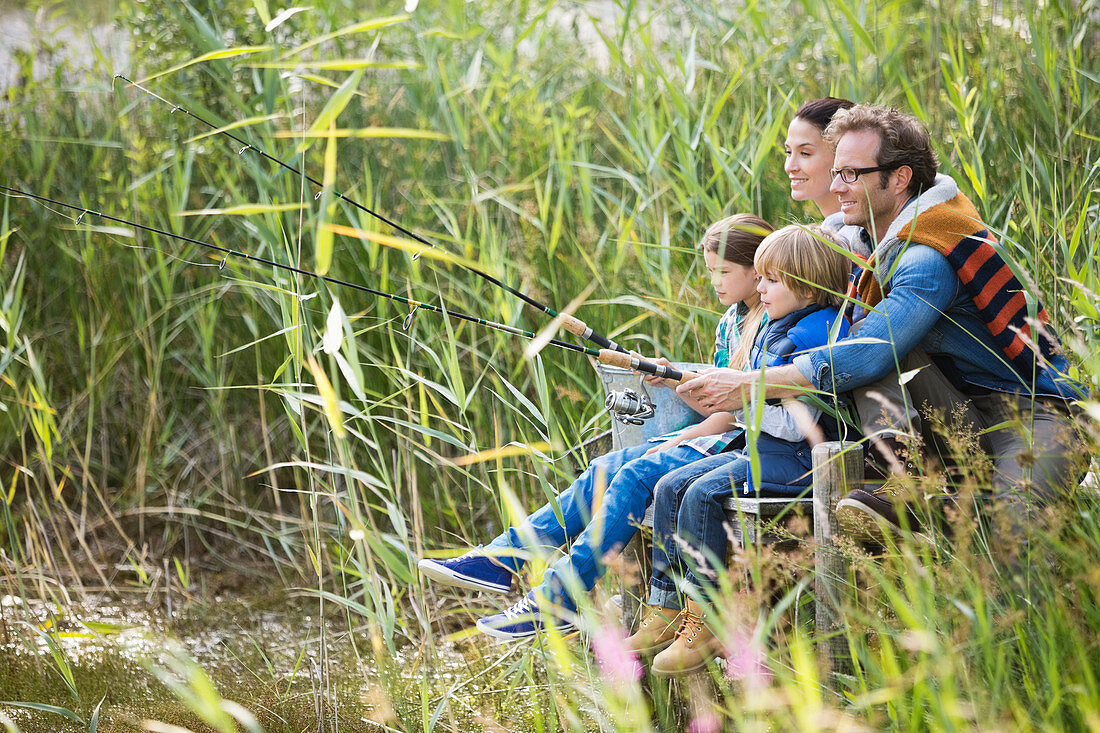 Family fishing together in tall grass